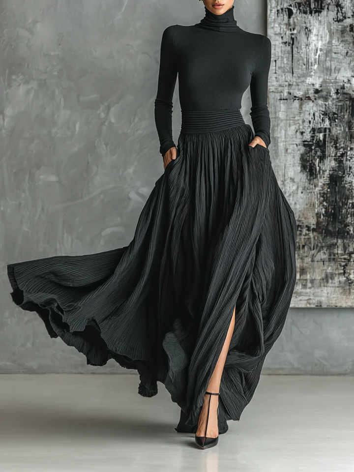 Marion | Black outfit with a turtleneck and a flowing pleated skirt
