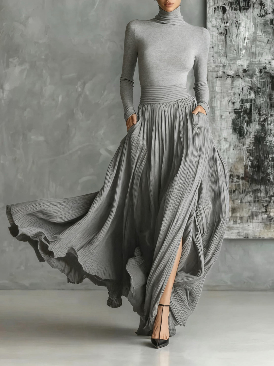 Marion | Black outfit with a turtleneck and a flowing pleated skirt