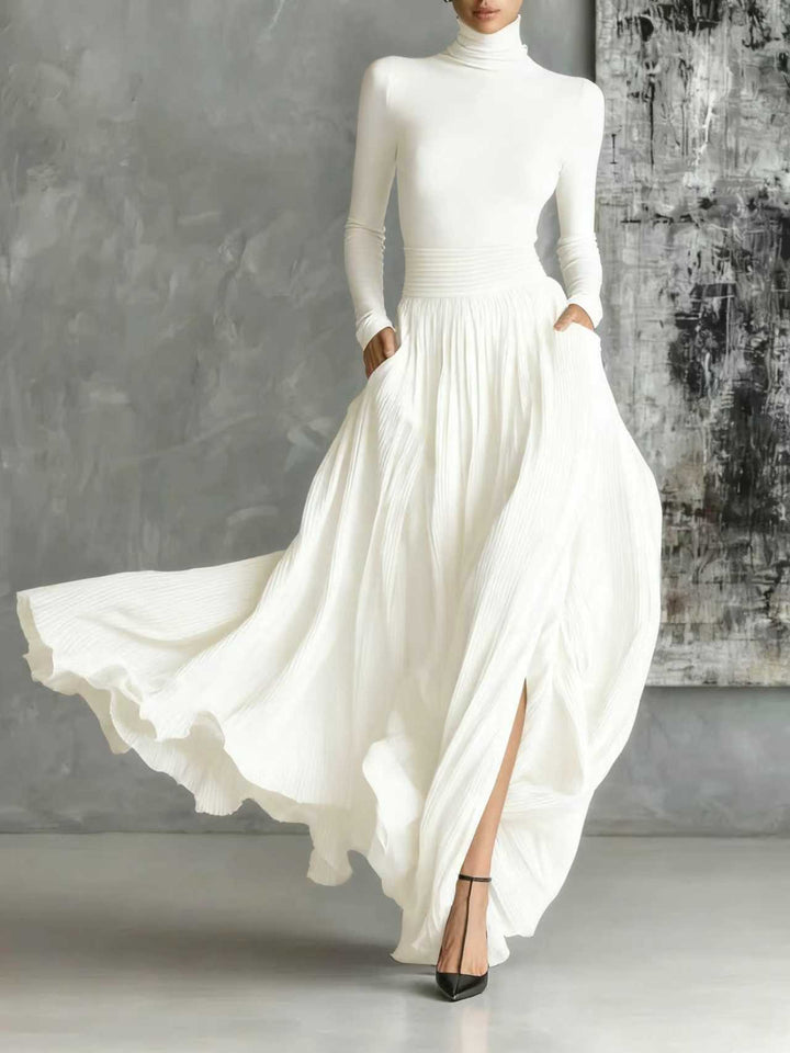 Marion | Black outfit with a turtleneck and a flowing pleated skirt